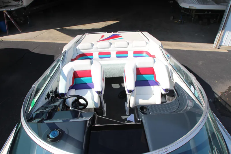 Slide: The Image of 1995 Formula SR1 303 boat interior with colorful seating and steering wheel. - 10