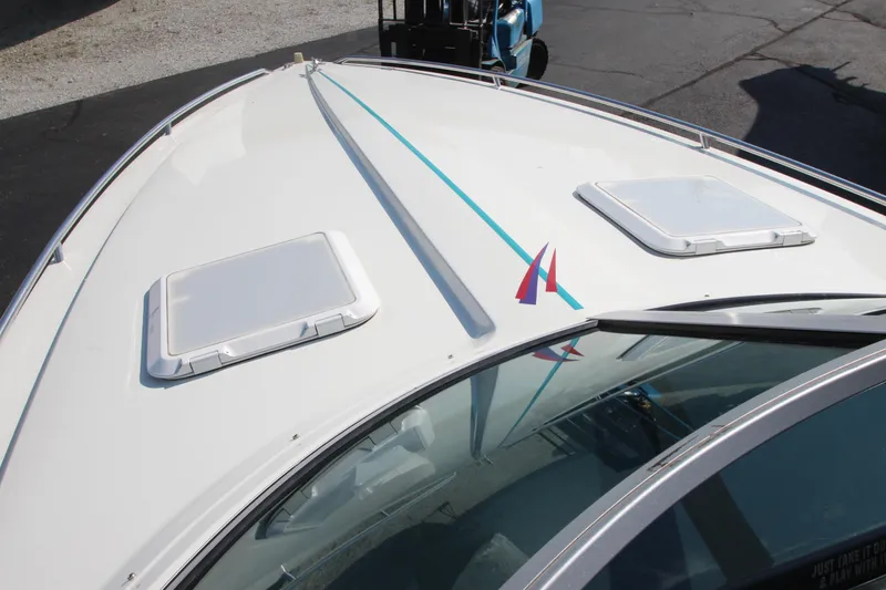 Slide: The Image of 1995 Formula SR1 303 boat deck with hatches and blue stripe. - 11