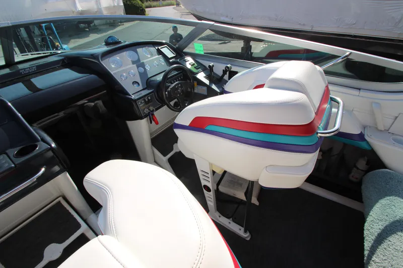 Slide: The Image of Interior of a 1995 Formula SR1 303 boat with colorful seating and dashboard. - 14