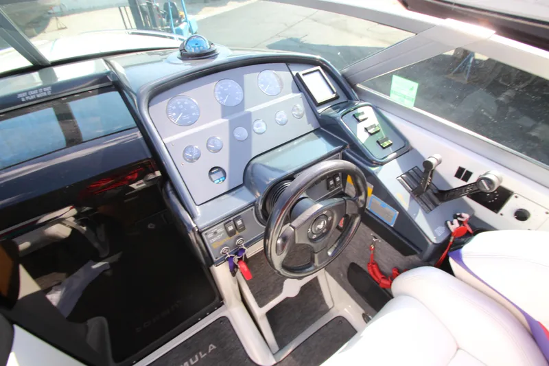 Slide: The Image of 1995 Formula SR1 303 boat cockpit with steering wheel and control panel. - 18