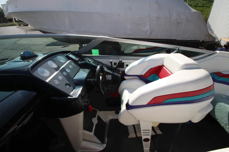 Slide: The Image of 1995 Formula SR1 303 boat interior with colorful seating and modern dashboard. - 19
