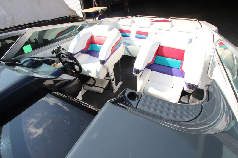 Slide: The Image of 1995 Formula SR1 303 boat interior with colorful seating and steering wheel. - 20