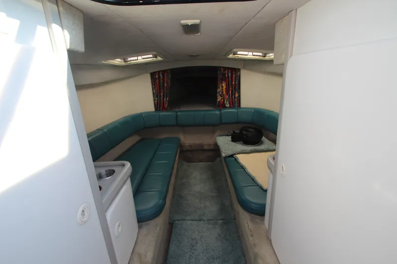 Slide: The Image of Interior of 1995 Formula SR1 303 boat with teal seating and compact layout. - 21