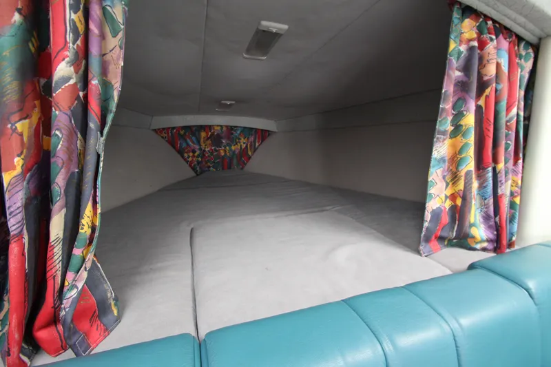 Slide: The Image of Interior cabin of 1995 Formula SR1 303 with colorful curtains and cushioned seating. - 23