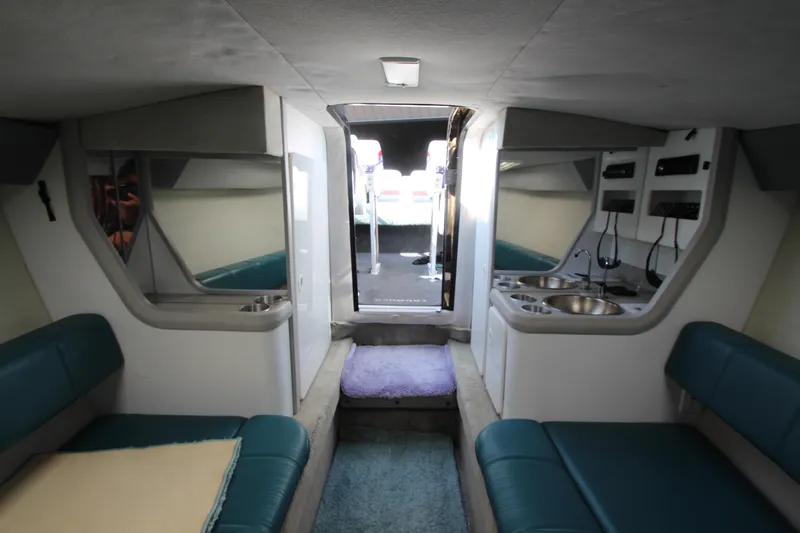 Slide: The Image of Interior of 1995 Formula SR1 303 boat with seating and kitchenette. - 24