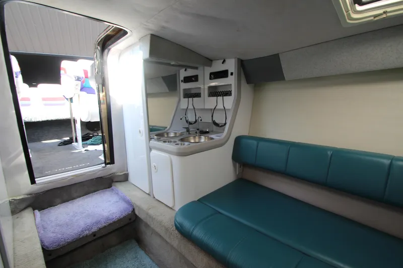 Slide: The Image of Interior of 1995 Formula SR1 303 boat with seating and kitchenette area. - 26