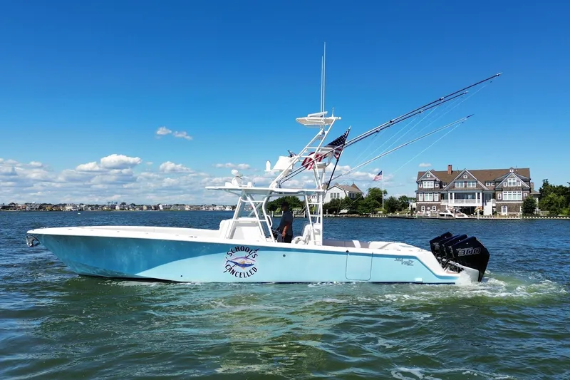 The Image of 2018 SeaVee 390Z boat cruising on a sunny day with waterfront homes in the background. - 0