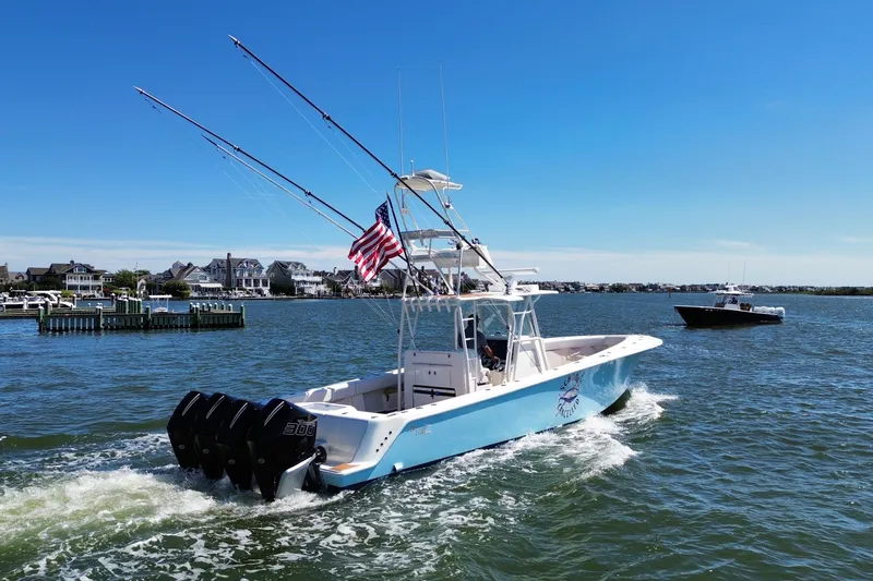 Slide: The Image of 2018 SeaVee 390Z boat cruising on a sunny day with American flag. - 18