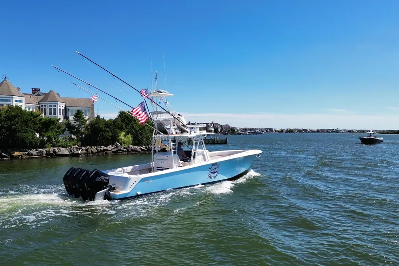 Slide: The Image of 2018 SeaVee 390Z boat cruising on a sunny day near waterfront homes. - 20