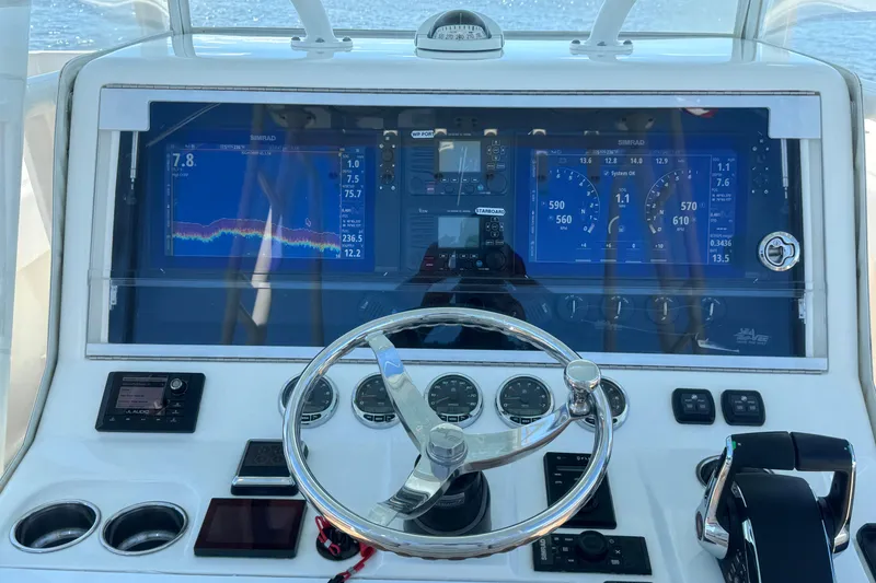 Slide: The Image of 2018 SeaVee 390Z boat dashboard with navigation screens and steering wheel. - 28