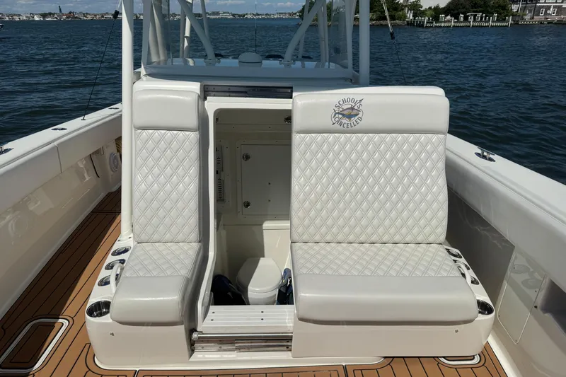 Slide: The Image of 2018 SeaVee 390Z boat interior with diamond-stitched seating and open storage compartment. - 31