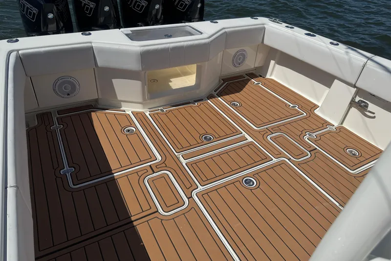 Slide: The Image of 2018 SeaVee 390Z boat deck with teak-style flooring and white accents. - 34