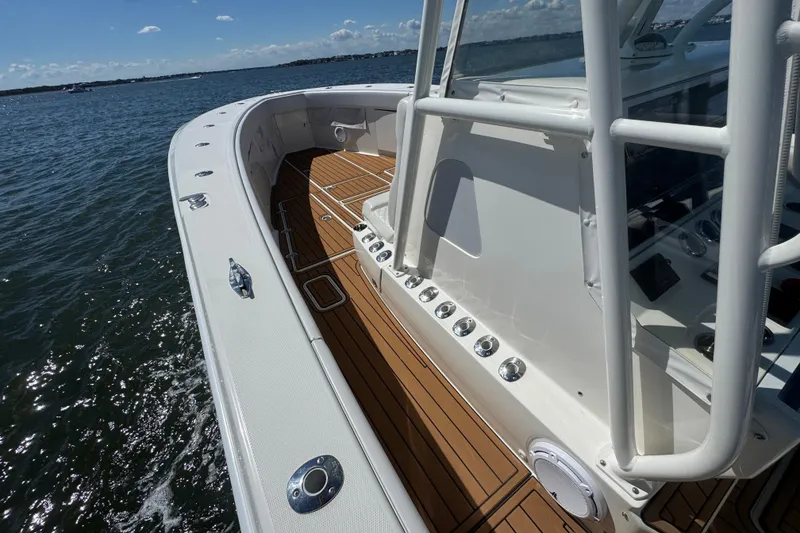 Slide: The Image of 2018 SeaVee 390Z boat with teak deck, cruising on open water. - 42