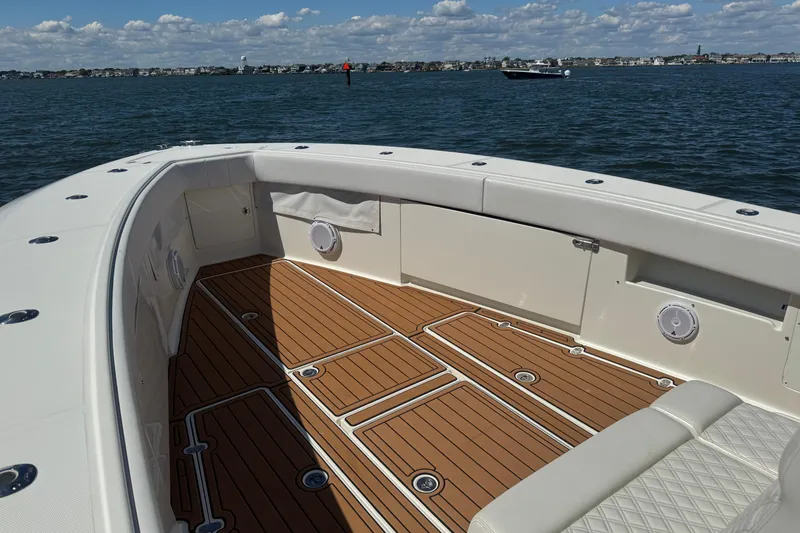 Slide: The Image of 2018 SeaVee 390Z boat with spacious deck and scenic ocean view. - 44