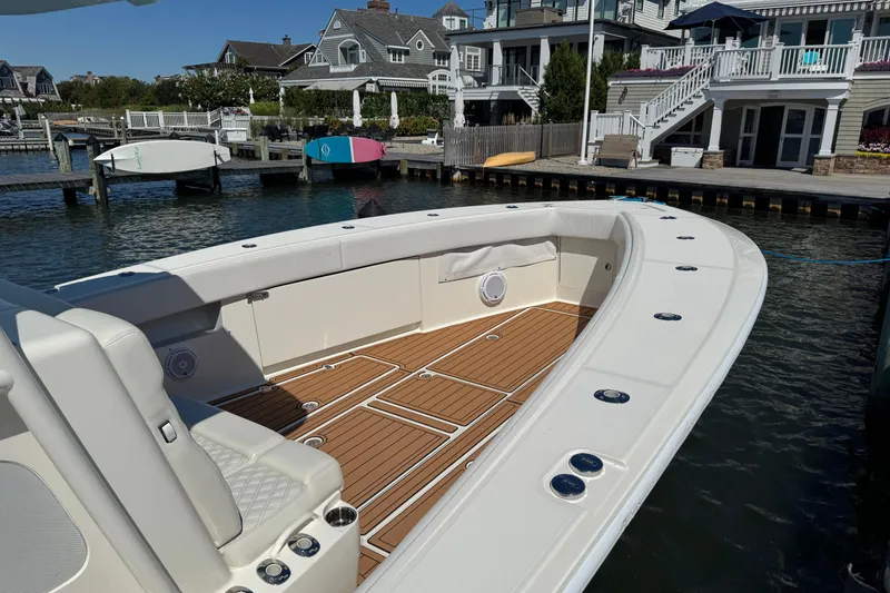 Slide: The Image of 2018 SeaVee 390Z boat docked, featuring spacious deck and modern design. - 50