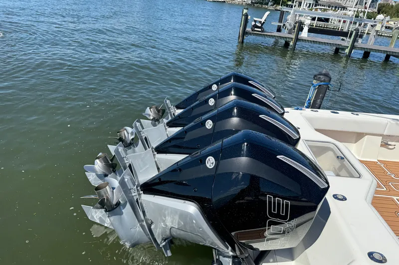 Slide: The Image of 2018 SeaVee 390Z boat with triple outboard engines docked by the water. - 51