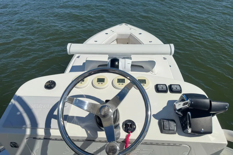 Slide: The Image of 2018 SeaVee 390Z boat helm with steering wheel and controls on open water. - 52