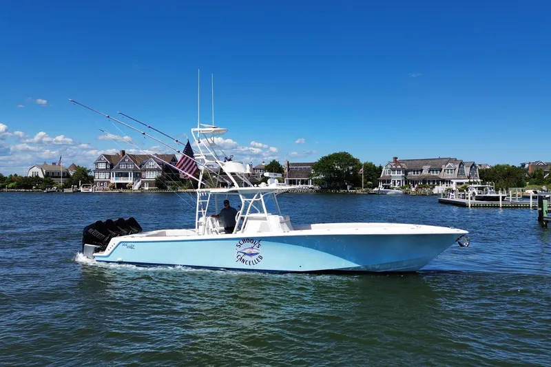 Slide: The Image of 2018 SeaVee 390Z boat cruising on a sunny day near waterfront homes. - 9
