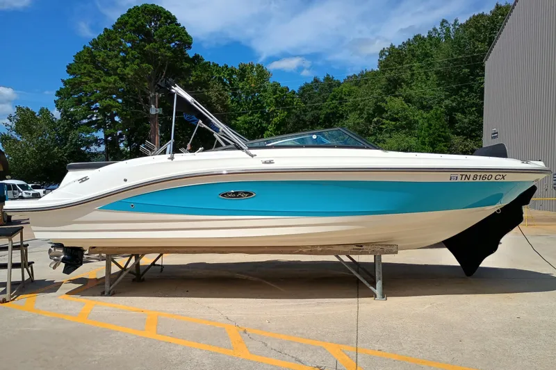Slide: The Image of 2022 Sea Ray SPX 230 boat on display, featuring a sleek blue and white design. - 1