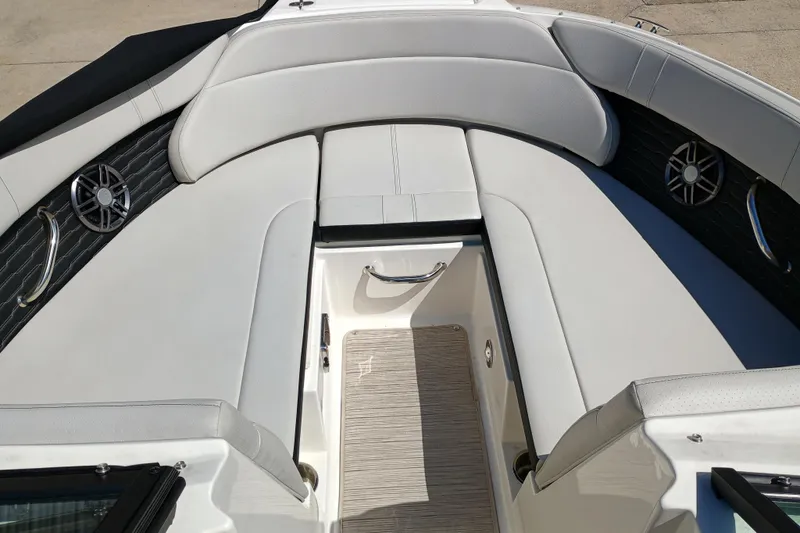 Slide: The Image of 2022 Sea Ray SPX 230 boat interior with white seating and built-in speakers. - 3