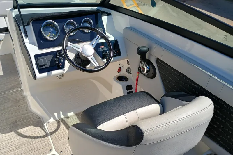 Slide: The Image of 2022 Sea Ray SPX 230 boat cockpit with steering wheel and control panel. - 4