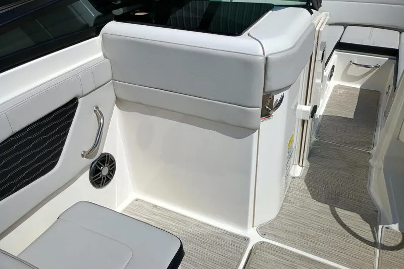 Slide: The Image of 2022 Sea Ray SPX 230 boat interior with white seating and modern design. - 5