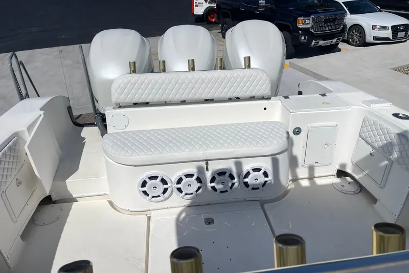Slide: The Image of 2002 Fountain 38 CC Tournament Edition boat interior with white seating and speakers. - 10