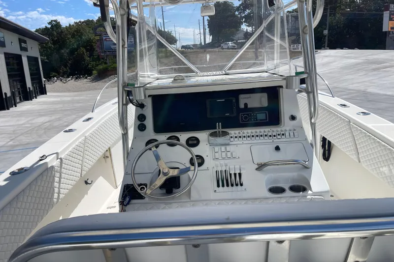 Slide: The Image of 2002 Fountain 38 CC Tournament Edition boat cockpit with steering wheel and control panel. - 14