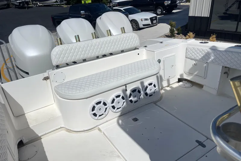 Slide: The Image of 2002 Fountain 38 CC Tournament Edition boat interior with white seating and speakers. - 17