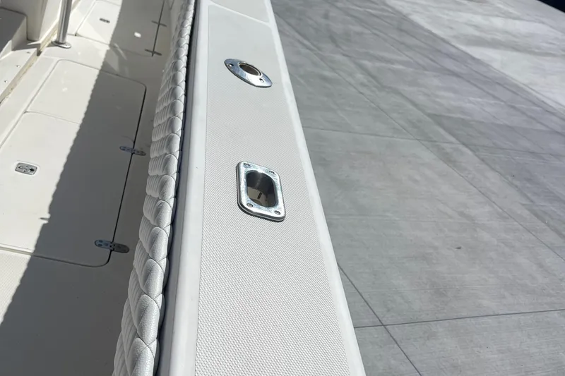 Slide: The Image of 2002 Fountain 38 CC Tournament Edition boat deck with rod holder and padded railing. - 18