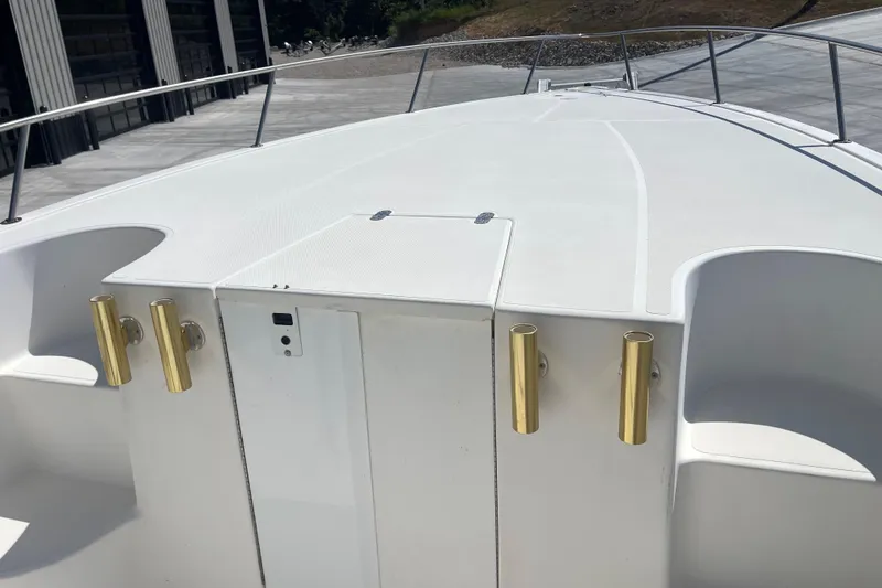 Slide: The Image of 2002 Fountain 38 CC Tournament Edition boat deck with gold rod holders. - 21