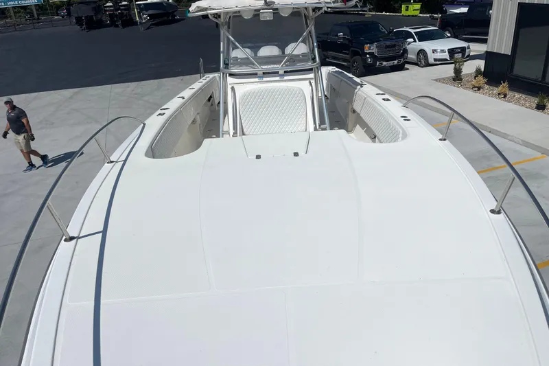 Slide: The Image of 2002 Fountain 38 CC Tournament Edition boat, white deck, parked outdoors. - 22