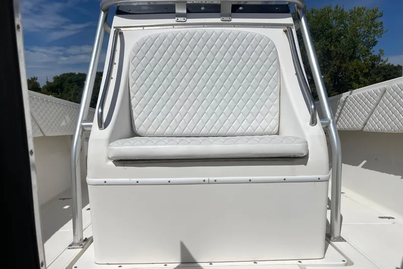 Slide: The Image of 2002 Fountain 38 CC Tournament Edition boat with white quilted seating and metal railings. - 27