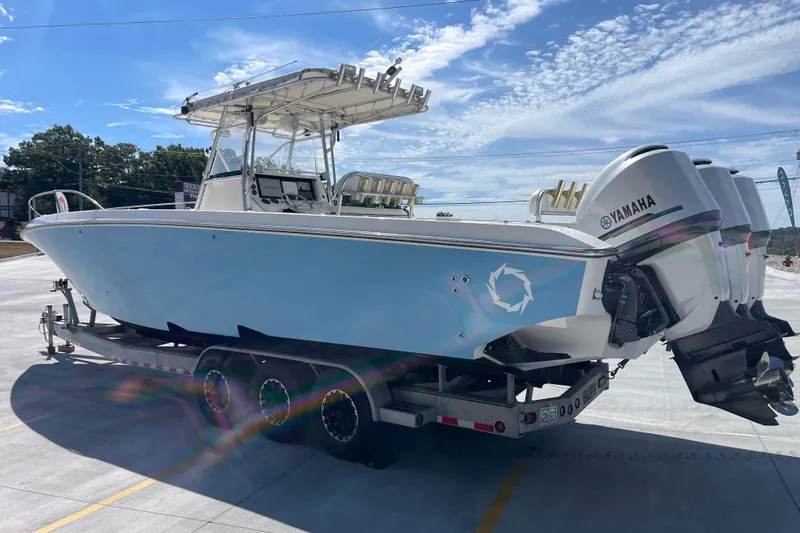 Slide: The Image of 2002 Fountain 38 CC Tournament Edition boat on trailer, featuring Yamaha engines. - 3