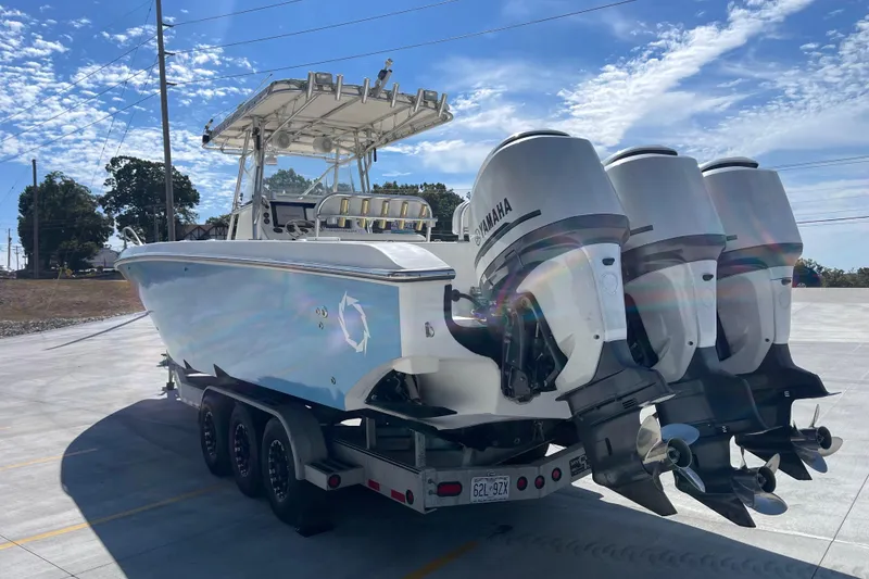 Slide: The Image of 2002 Fountain 38 CC Tournament Edition boat with Yamaha engines on a trailer. - 4