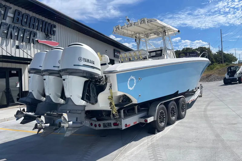 Slide: The Image of 2002 Fountain 38 CC Tournament Edition boat with Yamaha engines on a trailer. - 6