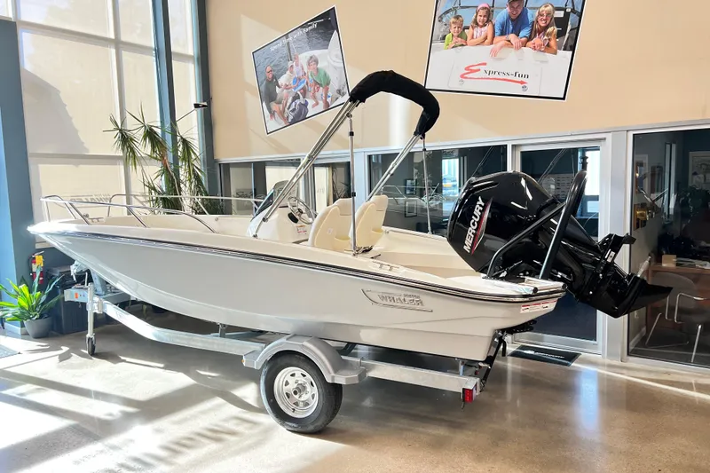 The Image of 2026 Boston Whaler 160 Super Sport boat displayed indoors on a trailer. - 0