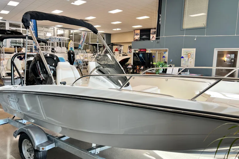 Slide: The Image of 2026 Boston Whaler 160 Super Sport boat displayed in a showroom setting. - 2