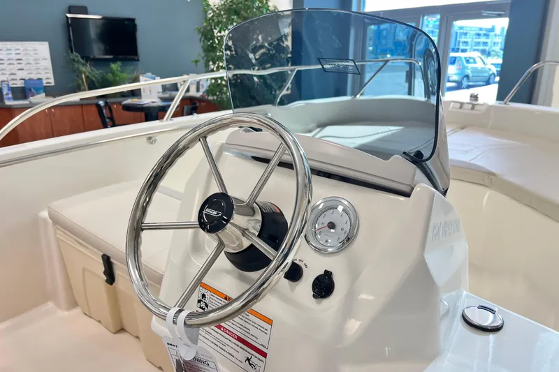 Slide: The Image of 2026 Boston Whaler 160 Super Sport boat interior with steering wheel and dashboard. - 3