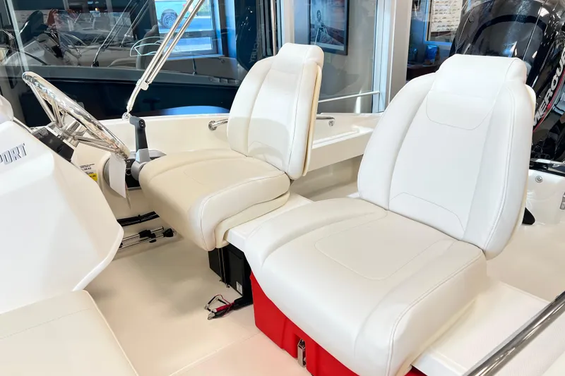 Slide: The Image of 2026 Boston Whaler 160 Super Sport interior with white seating and steering wheel. - 4