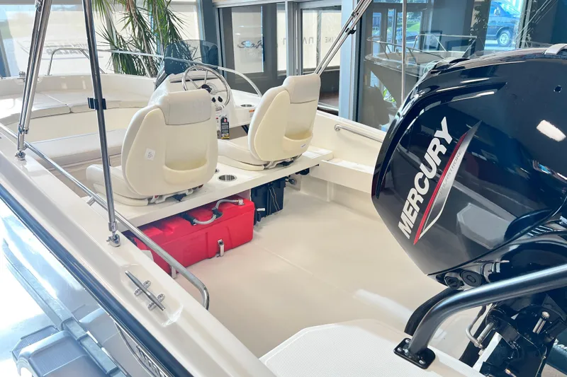 Slide: The Image of 2026 Boston Whaler 160 Super Sport boat interior with Mercury engine, showroom display. - 6