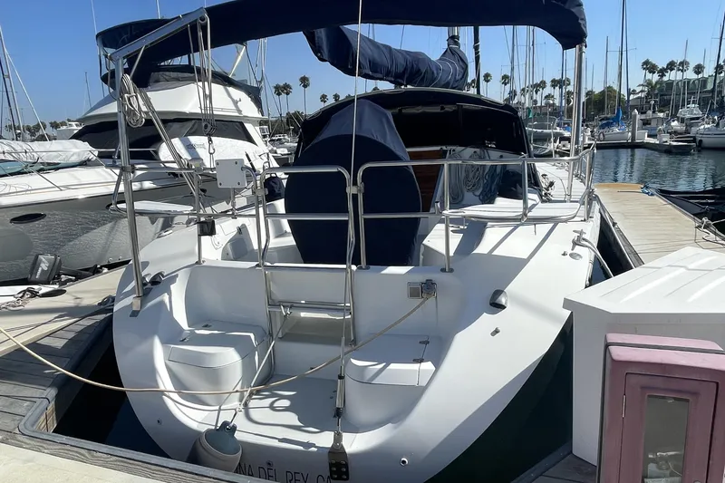 Slide: The Image of 2001 Catalina 42 sailboat docked at marina, featuring sleek design and spacious deck. - 1