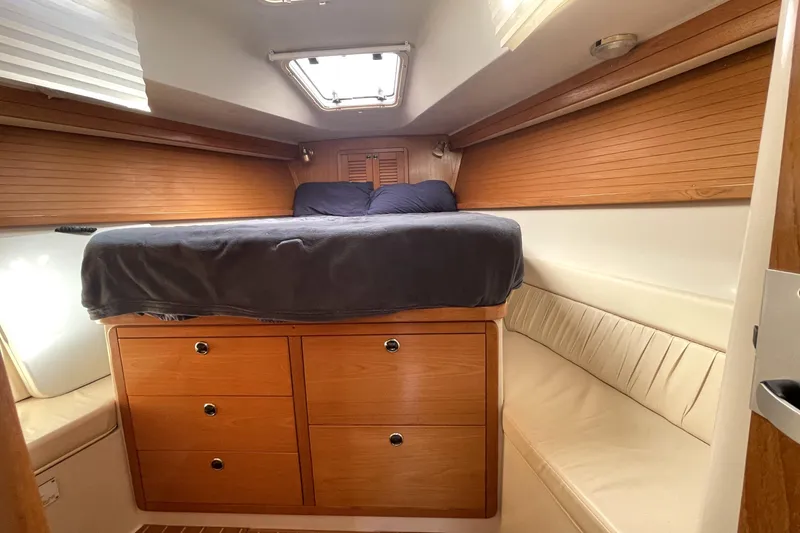 Slide: The Image of Cozy cabin interior of 2001 Catalina 42 sailboat with wooden drawers and bed. - 15