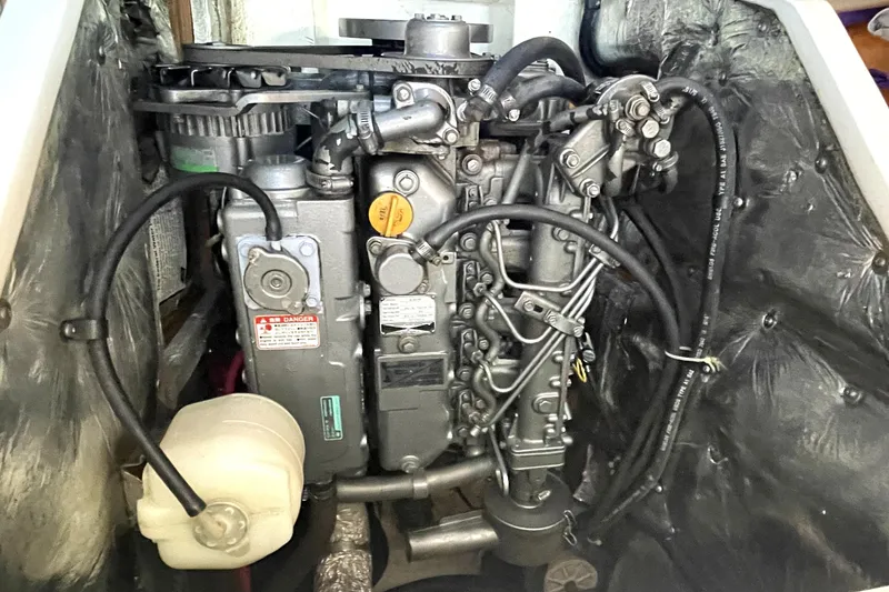 Slide: The Image of Engine compartment of a 2001 Catalina 42 sailboat, showcasing detailed mechanical components. - 17