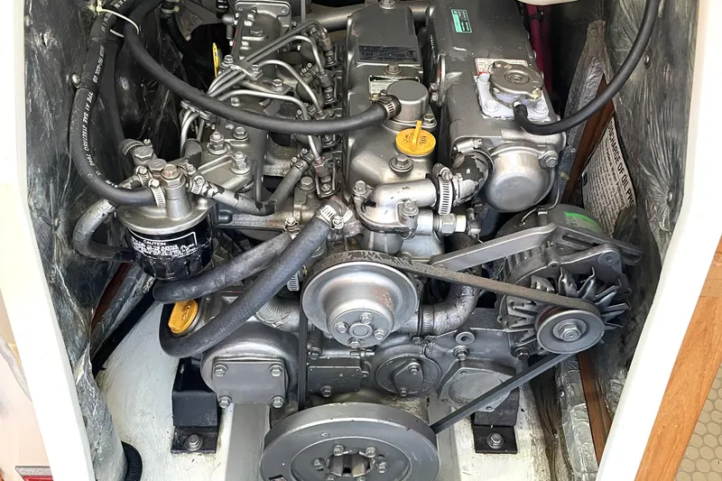 Slide: The Image of Engine compartment of a 2001 Catalina 42 sailboat, showcasing mechanical components and belts. - 18