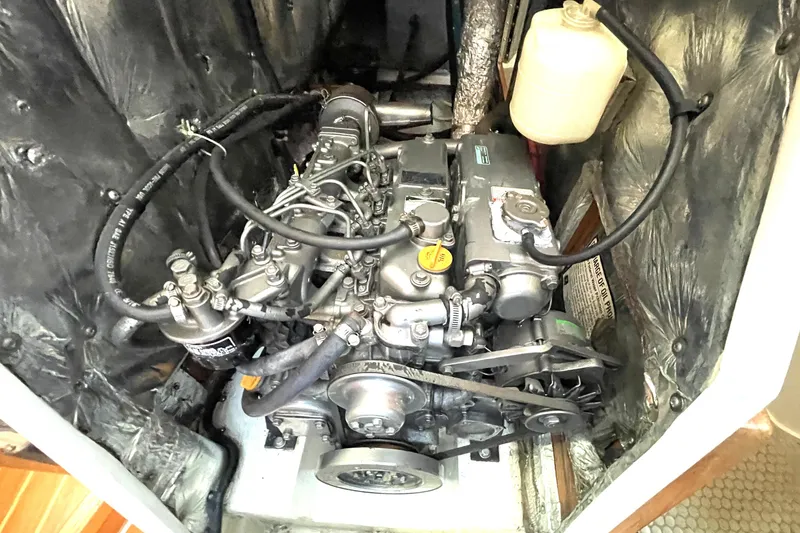 Slide: The Image of Engine compartment of a 2001 Catalina 42 sailboat, showcasing detailed mechanical components. - 19