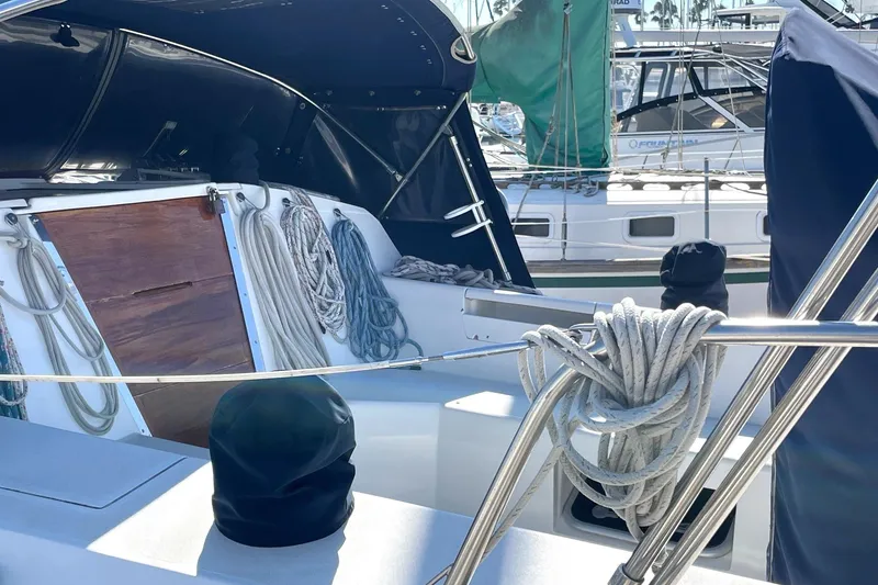 Slide: The Image of 2001 Catalina 42 sailboat cockpit with ropes and covered equipment in marina. - 25