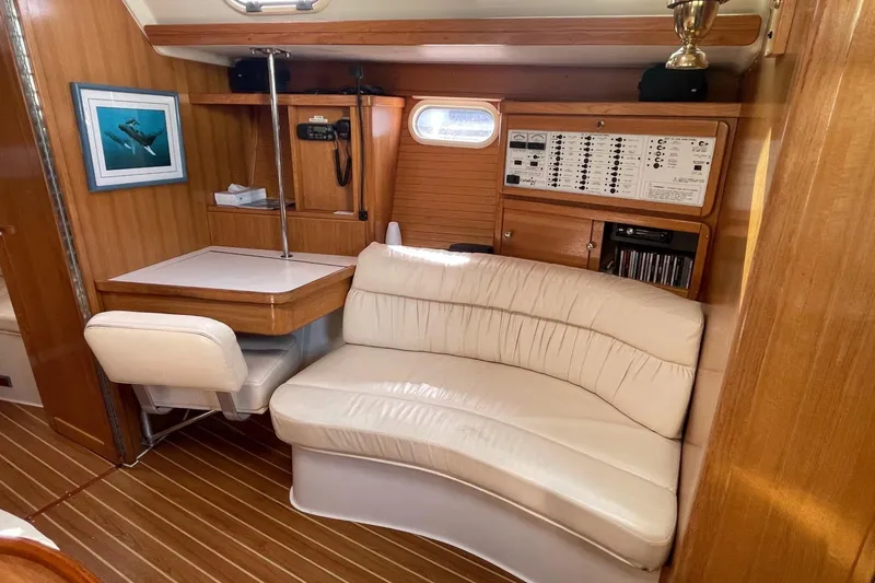 Slide: The Image of Interior of 2001 Catalina 42 yacht with seating, table, and control panel. - 4