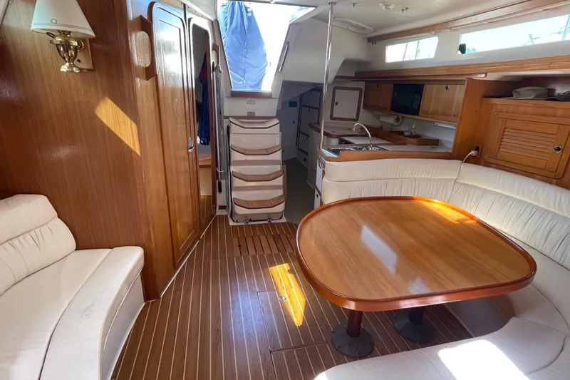 Slide: The Image of Interior of a 2001 Catalina 42 yacht with wooden furnishings and cozy seating area. - 5