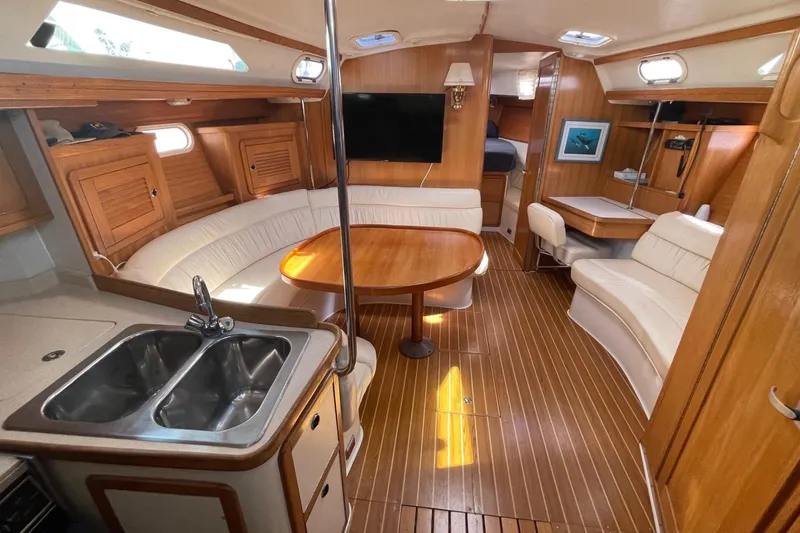 Slide: The Image of Interior of a 2001 Catalina 42 sailboat with wood finish and cozy seating area. - 7
